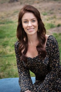 Sandi Forsythe sitting outdoors smiling