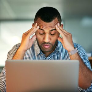 Stressed man looking at his computer