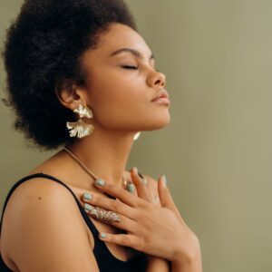 Woman clutching her chest and practicing mindfulness.