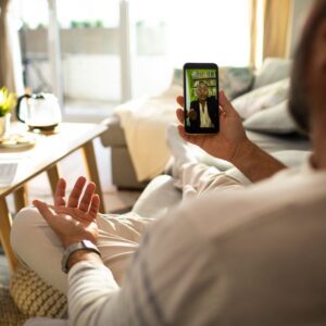 man talking to therapist over phone video call 