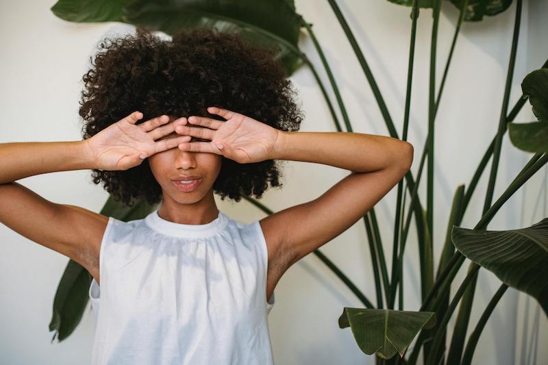 woman covering eyes