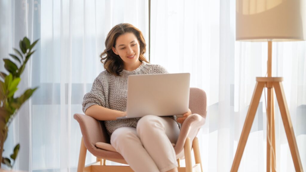 woman in chair using laptop