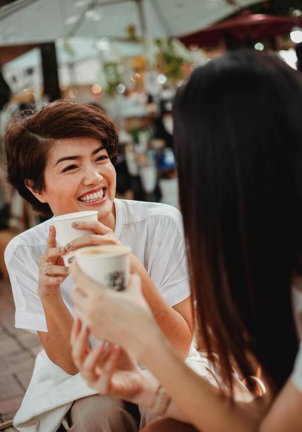 women having coffee together smiling