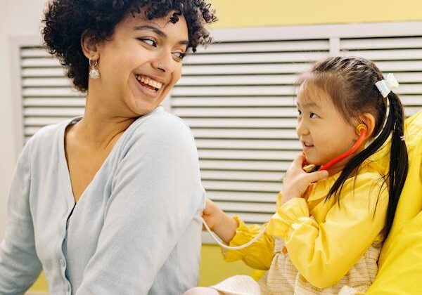 woman and child playing doctors